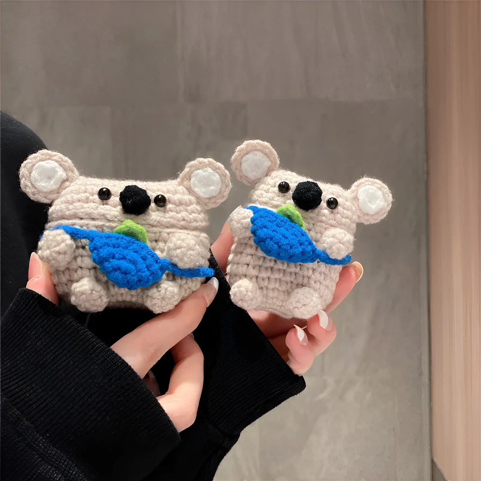Handmade knitted AirPods protective cover with backpack koala bear design showing front and side views