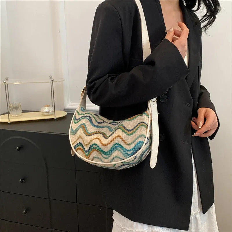 Women's knitted straw woven crossbody bag showing internal phone and file compartments