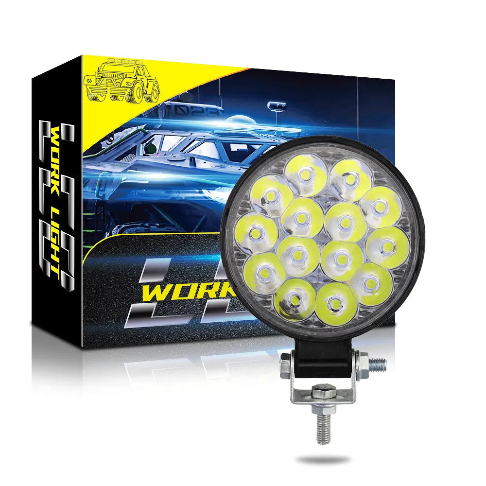 Mini round aluminium car LED work light with white light, shown for off-road vehicle installation.
