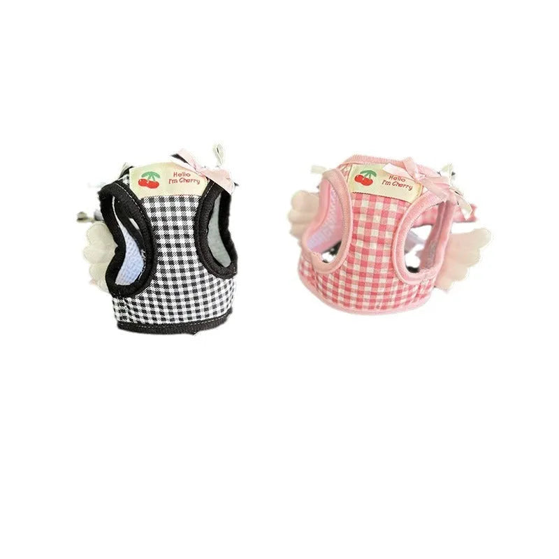 Small dog wearing pink cotton chest-back harness with hand holding rope attached