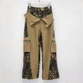 Dark khaki leopard print high-waist jeans with contrast stitching and straight leg.