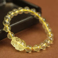 Yellow leather bracelet with artificial citrine crystals and a traditional Chinese Pi Xiu charm.