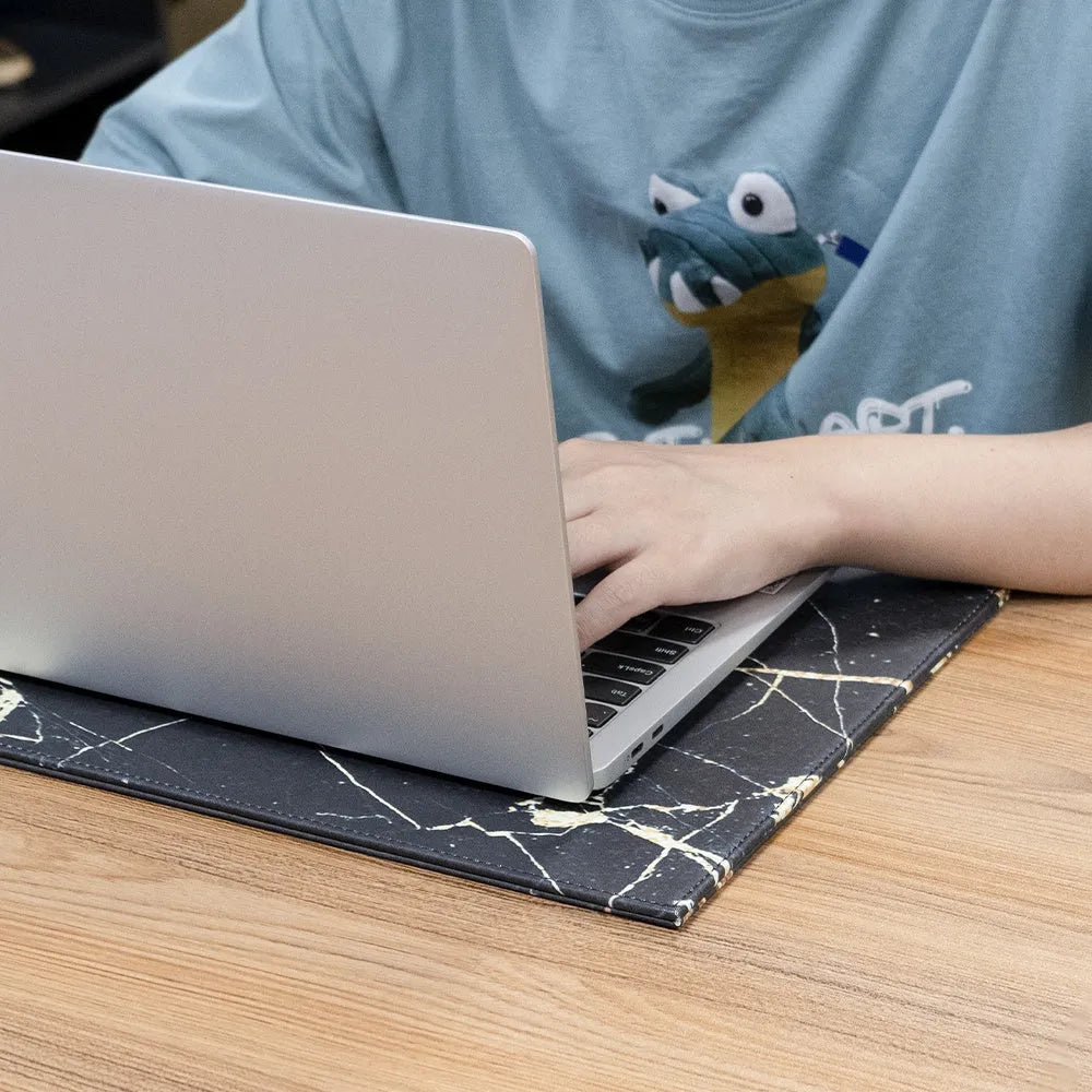 A4 anti-radiation laptop cooling pad with waterproof PU leather cover in various colours on a desk.