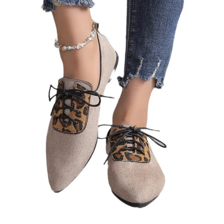 Beige leopard print women's pointed toe pumps on a white background, side view.
