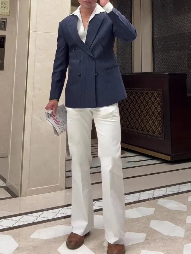 Men's striped double-breasted blazer on a hanger, showing regular fit and polyester construction.