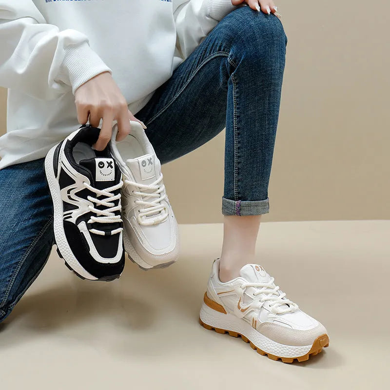 Women's flat-heel casual sports shoes in black with round toe and front lace-up design.