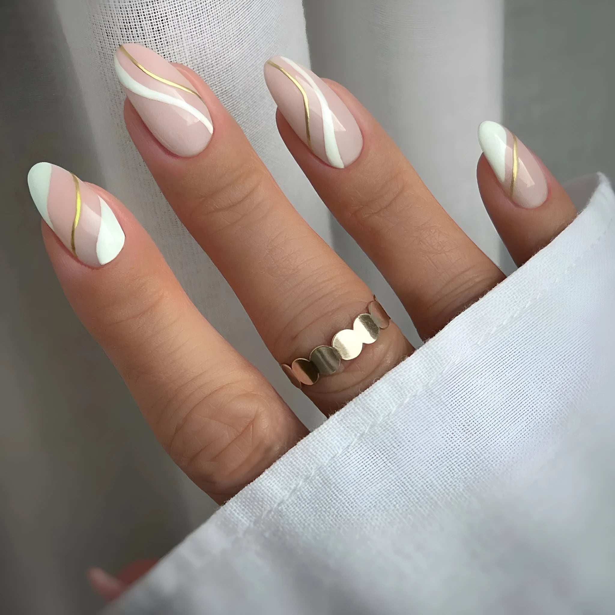 Golden lines plaid pattern on medium drop-shaped wearable nail stickers with jelly glue adhesive.