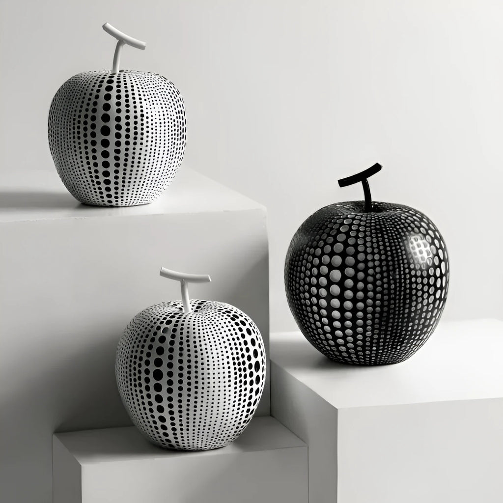 Resin decorative fruit crafts showing apple and pear shapes in black, white and orange colours