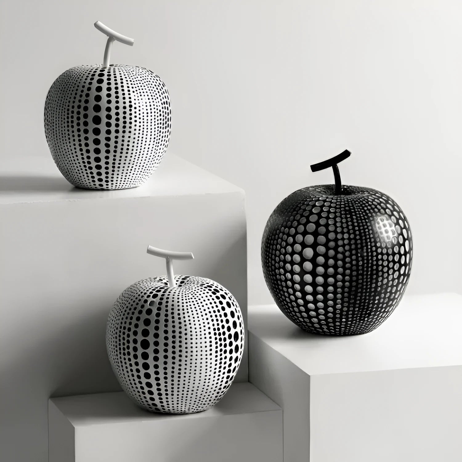Resin decorative fruit crafts showing apple and pear shapes in black, white and orange colours