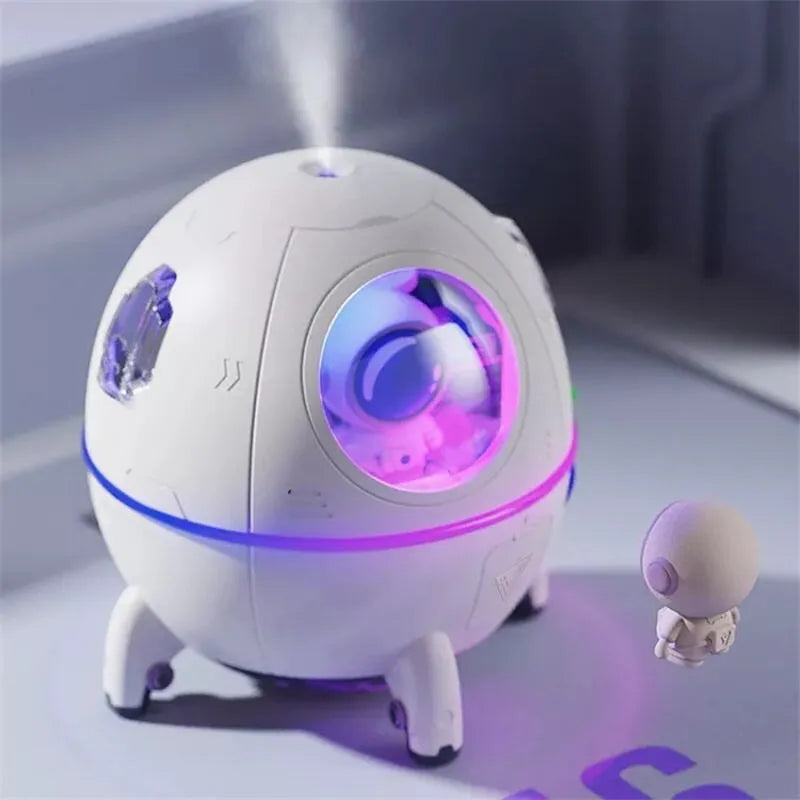 Purple astronaut-shaped USB desktop humidifier with colourful LED lights showing 220ml water capacity