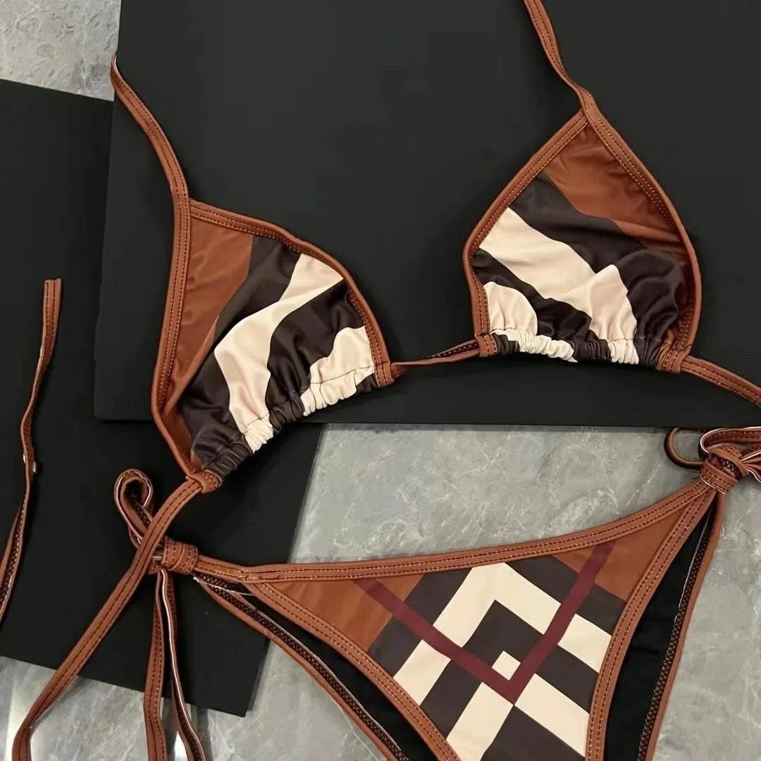 Women's black and white floral bikini set with split briefs on a beach