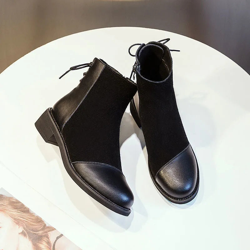 Black women's Martin boots with side zip, round toe, and knee-length shaft