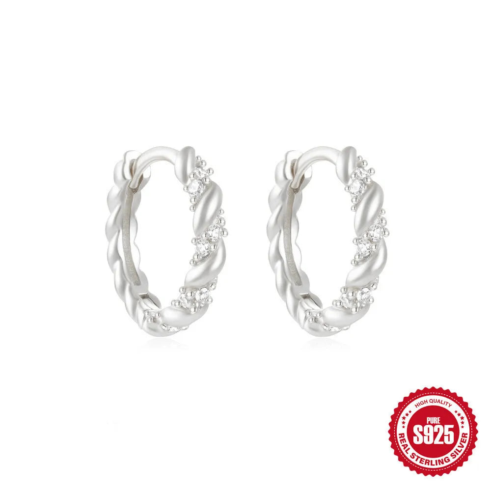 Sterling silver geometric stud earrings with circular diamond-style design in gold and silver electroplated finishes