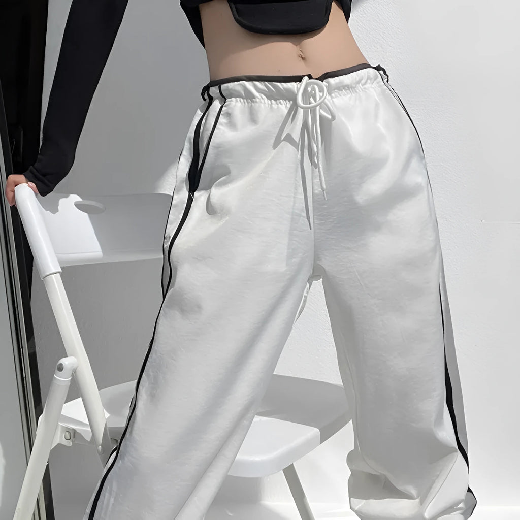 Navy blue and white loose straight leg trousers with ribbon parallel bars detail.