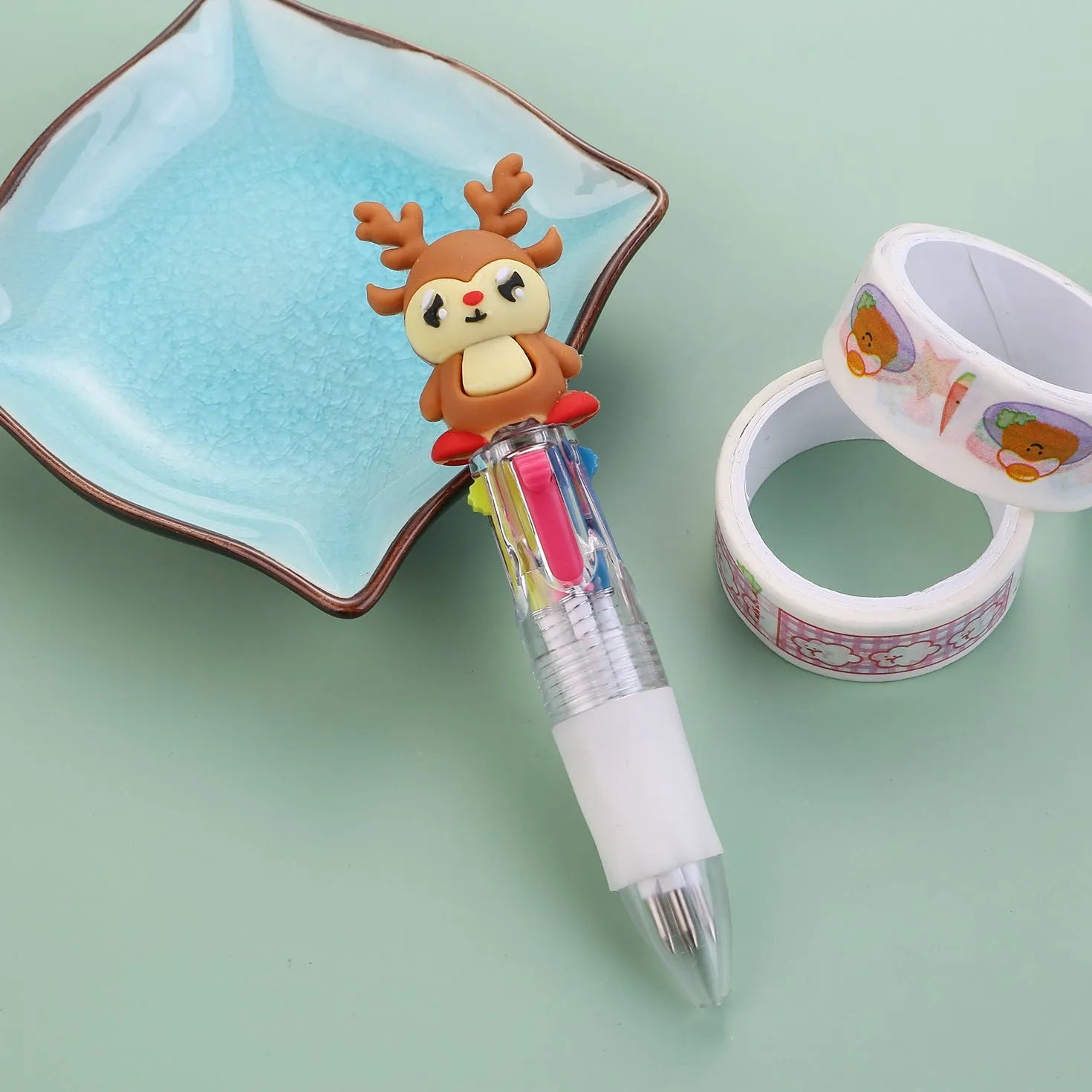 11cm long Christmas-themed four-colour ballpoint pen showing festive designs like reindeer and trees.