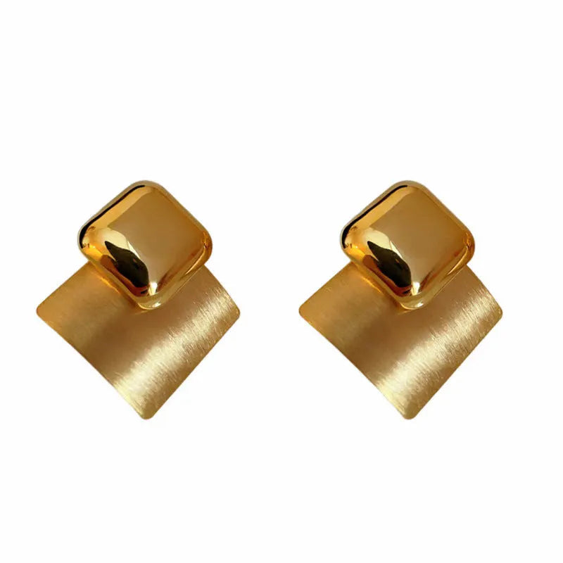 Women's gold brushed square stud earrings with 925 silver needle posts on a light background