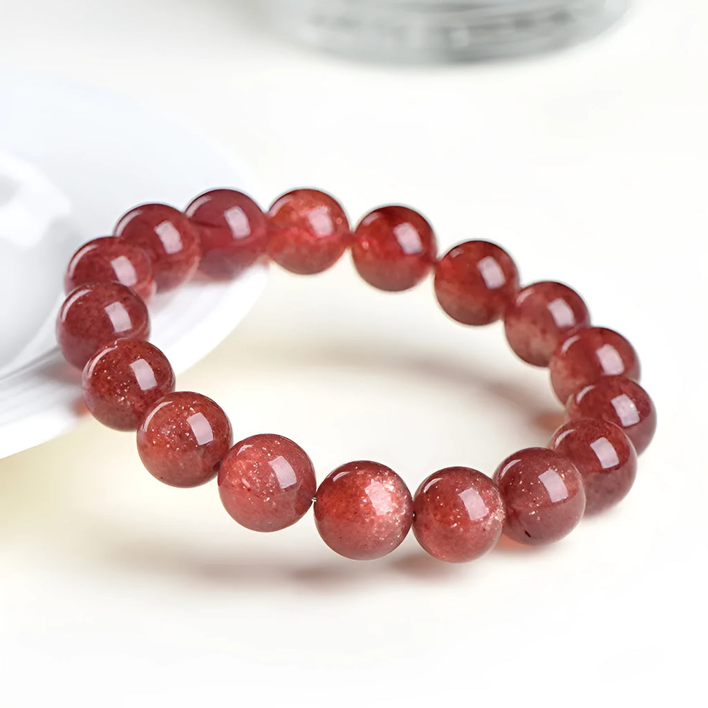 Natural strawberry quartz crystal bracelet with geometric beads showing starry inclusions