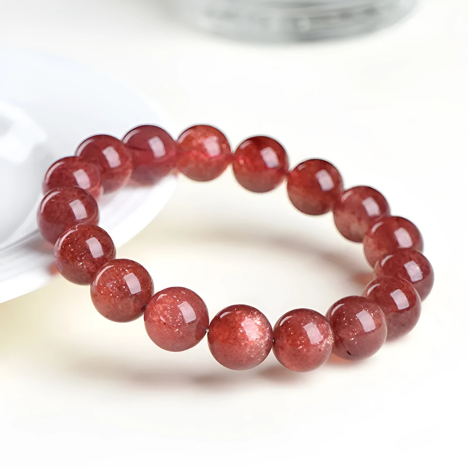 Natural strawberry quartz crystal bracelet with geometric beads showing starry inclusions