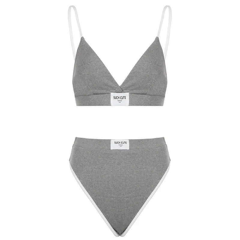 Women's grey bikini set with embroidery detail and contrast colour binding on a shorts-length bottom.