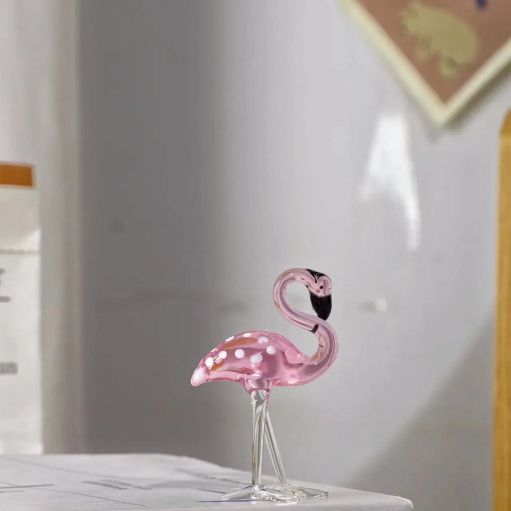 Pink crystal flamingo decorative sculpture on a table, modern simple style.