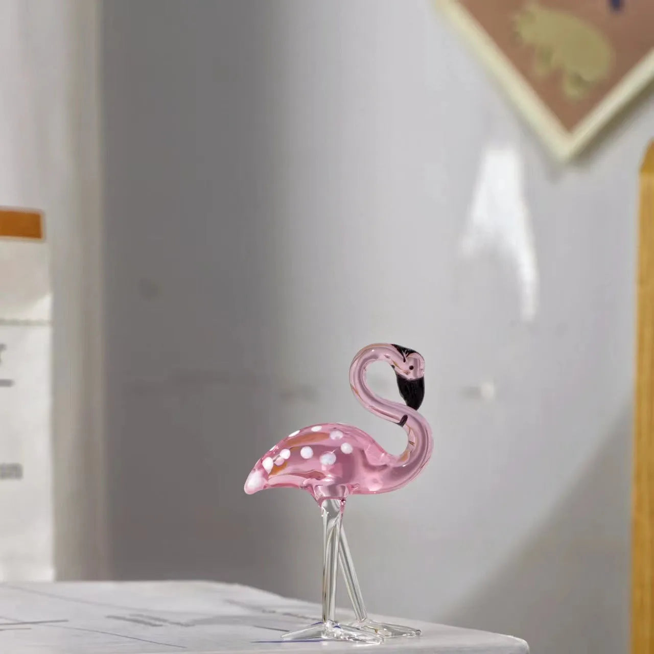 Pink crystal flamingo decorative sculpture on a table, modern simple style.