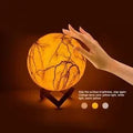 3D painted moon LED night light in 15cm size with warm glow on wood bracket