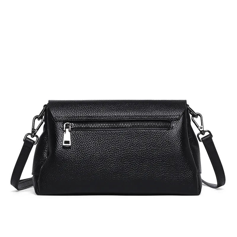 Women's soft cowhide shoulder bag in Wine Red with three main pockets and adjustable strap on white background