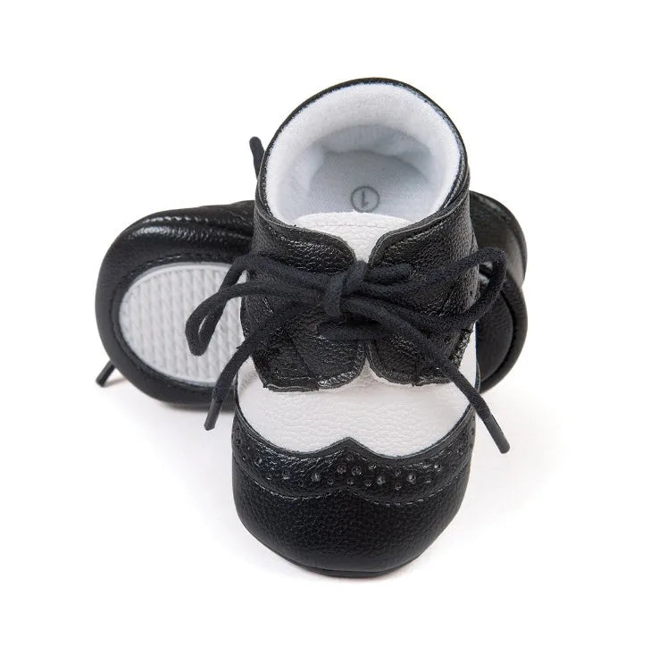 Vintage style soft-soled baby walking shoes for boys in black, grey, light brown, and white.