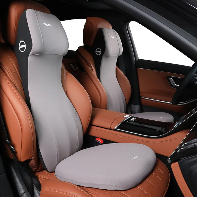 Black integrated memory foam car cushion and lumbar support pillow on a car seat.