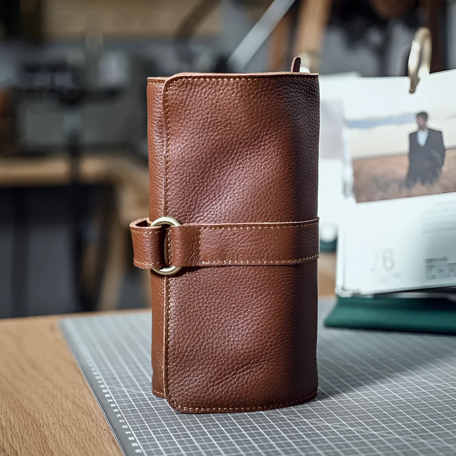 Handmade cow leather vintage wallet in black, showing tape extraction closure.