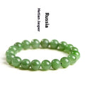 Polished Hetian jade bead bracelet in natural jasper colour on a wrist.