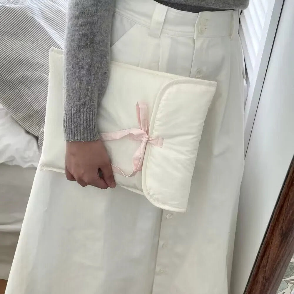 Black and white striped quilted laptop bag with ballet-style bow for women