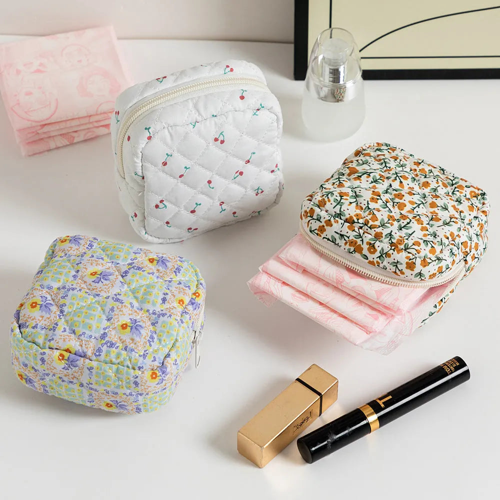 Small floral polyester key storage wallet with sewing thread detail in multiple colour patterns.