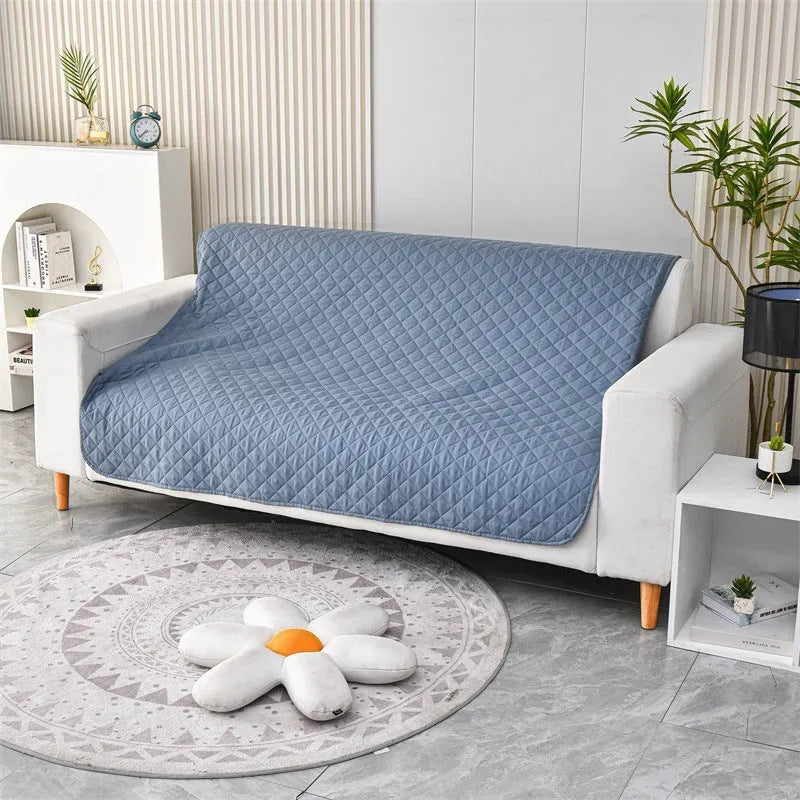 Waterproof reversible dog blanket on a sofa, showing two colour sides, with size chart for nine options.