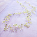 Bride's long hair band with crystal and pearl decoration in gold, silver, or rose gold colour options.