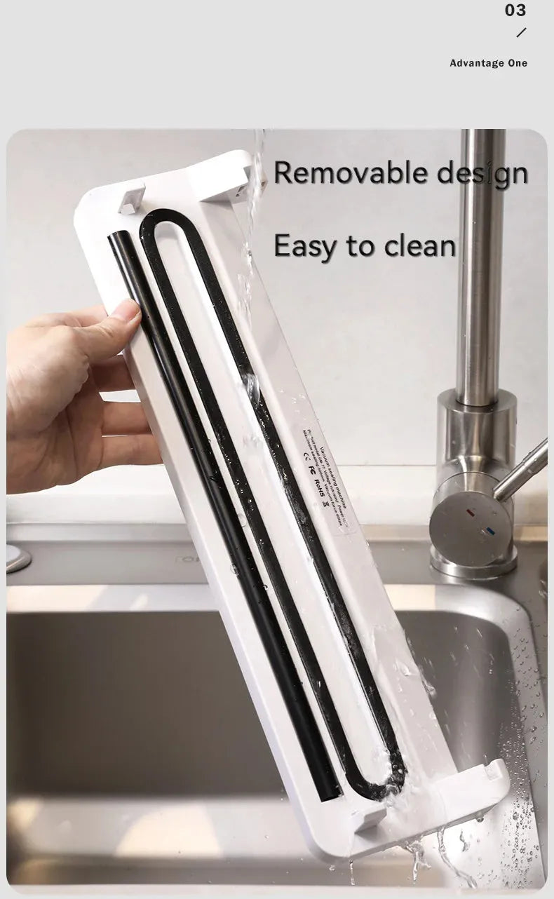 White compact automatic vacuum sealer machine for household food preservation on kitchen counter