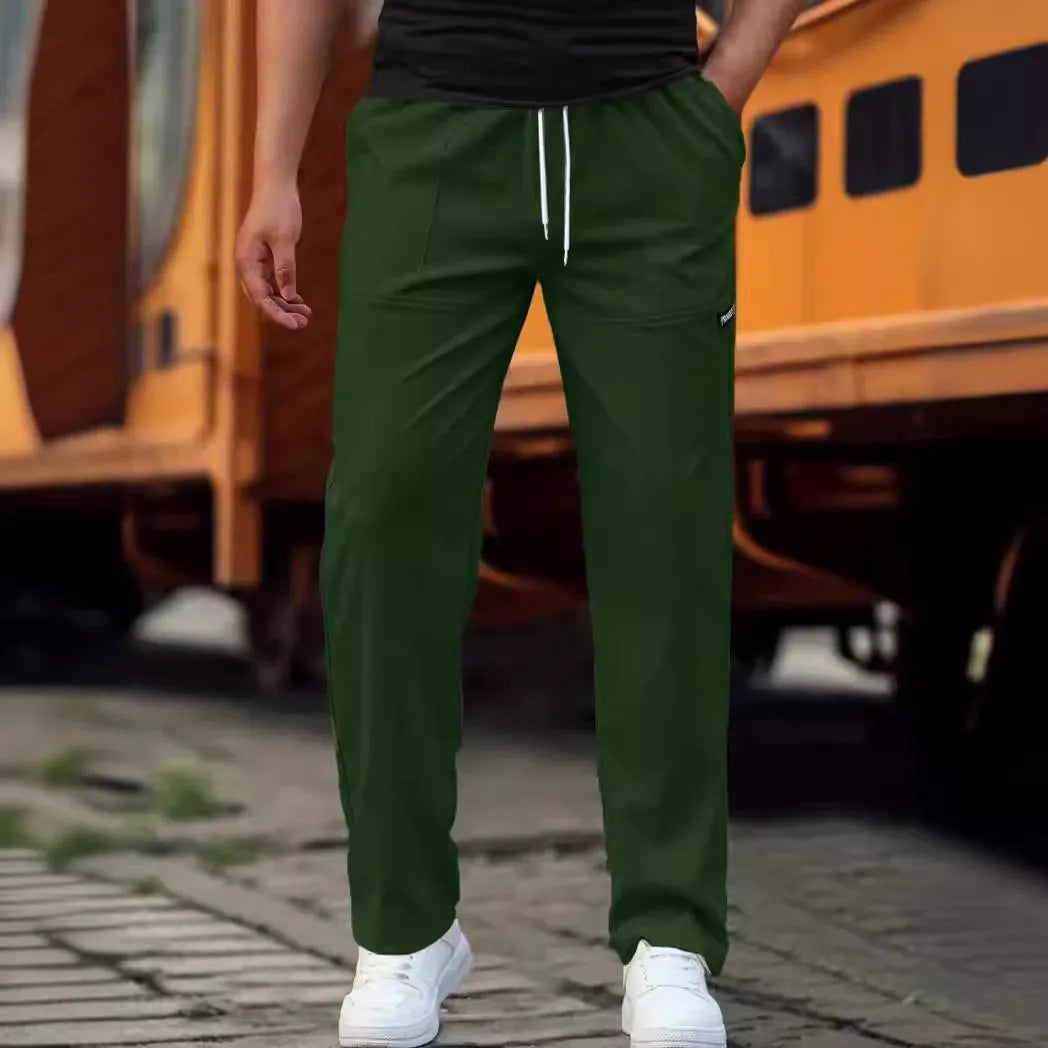Man wearing lightweight grey polyester trousers, showcasing fit and casual style for spring or autumn.