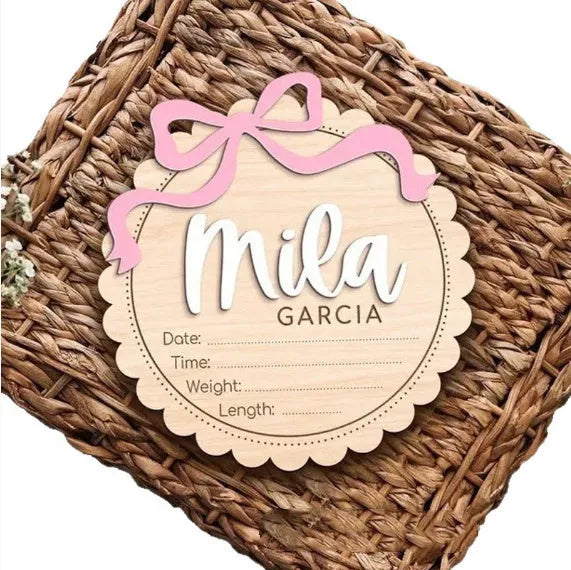 Square wooden baby room ornament with space for a customised name, shown in two size options.