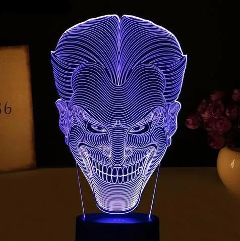 USB-powered acrylic 3D LED table lamp displaying blue light on a desk