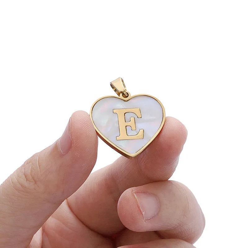 Gold plated heart-shaped necklace with a personalised initial letter and white shell detail on a 50cm adjustable chain.