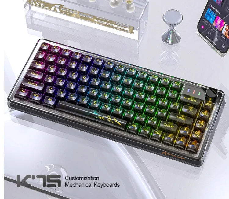 Attack Shark K75 white transparent wireless mechanical keyboard with RGB backlight on a desk.