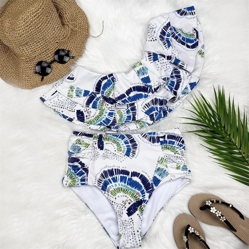 White women's one-shoulder swimsuit with a large decorative lotus leaf layer on the front.