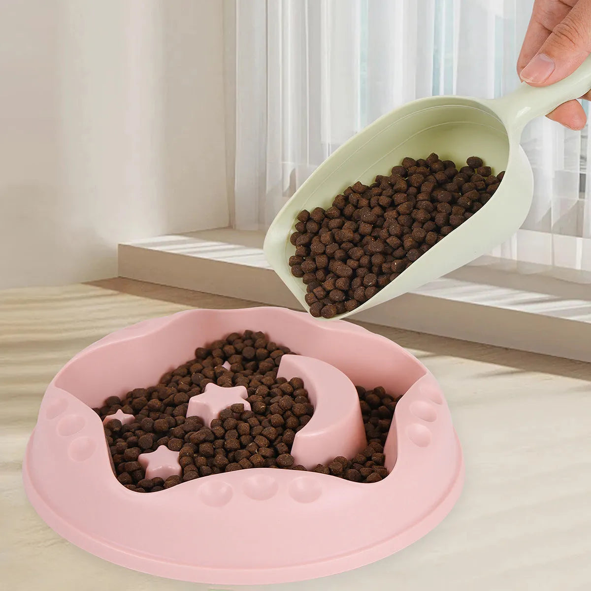 Large blue slow feeder dog bowl with raised moon and star wing patterns and a non-slip rubber base.