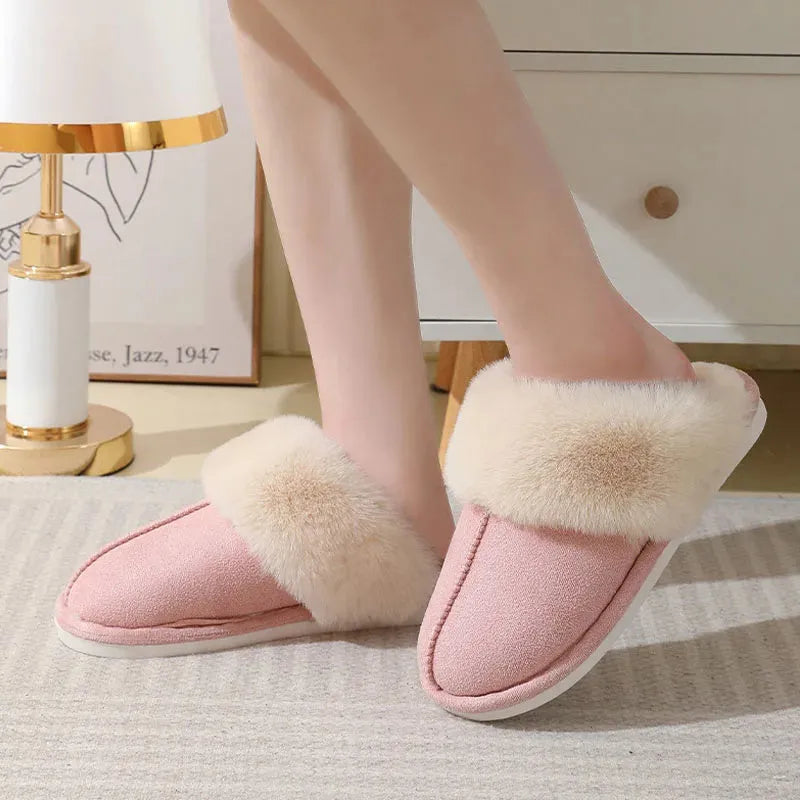 A pair of brown plush winter slippers with a round toe, flat heel, and non-slip PVC sole.