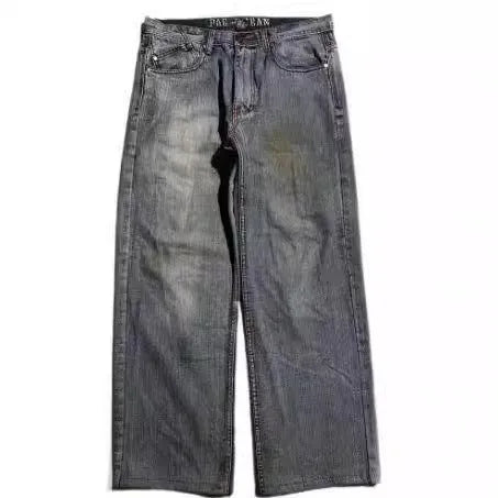 Grey washed-out denim jeans on a man, showing wide-leg straight cut and mid-waist fit.