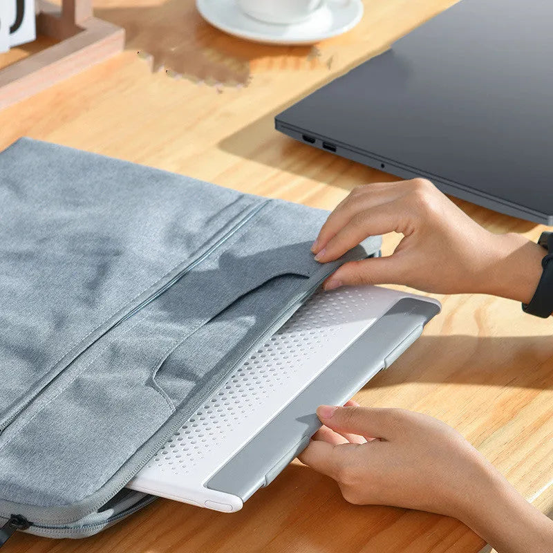 Dongdong portable alloy notebook stand in black on a desk under a laptop