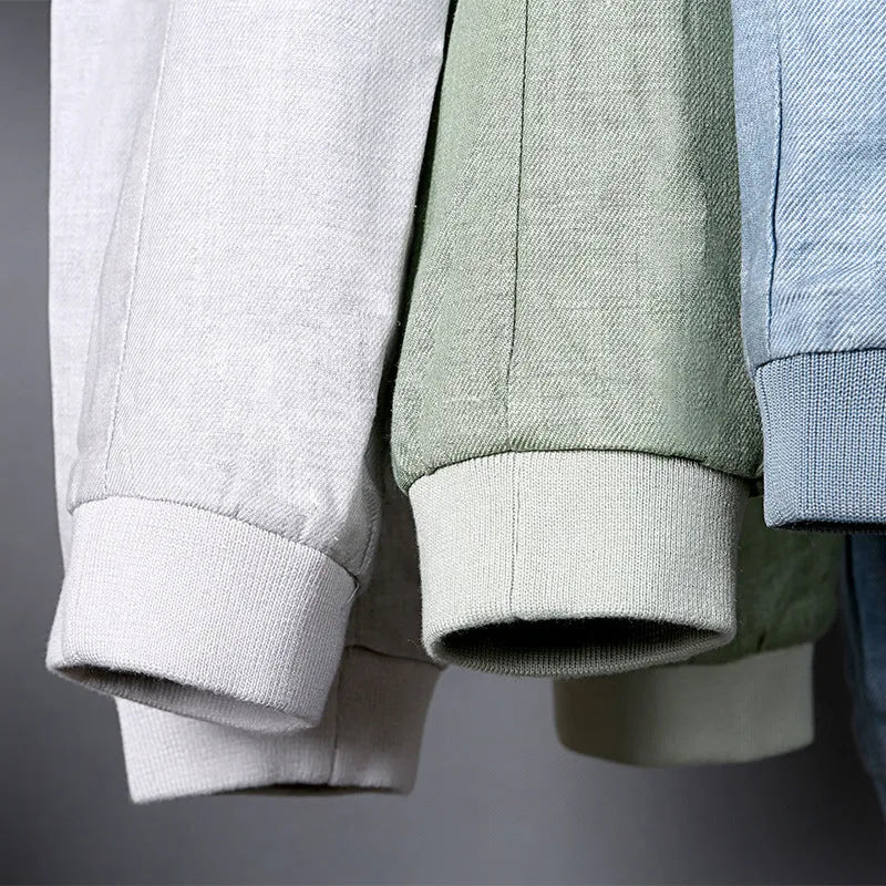 Men's thin blue cotton linen jacket on a hanger, showing regular cut and front button design.