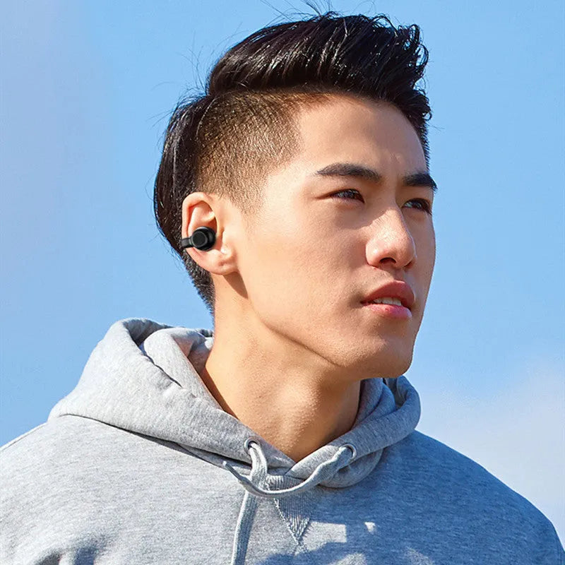 Black wireless clip-on bone conduction Bluetooth earphones with charging cable