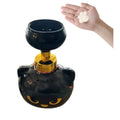 Black cartoon cat-shaped plastic foam soap dispenser on a bathroom sink.