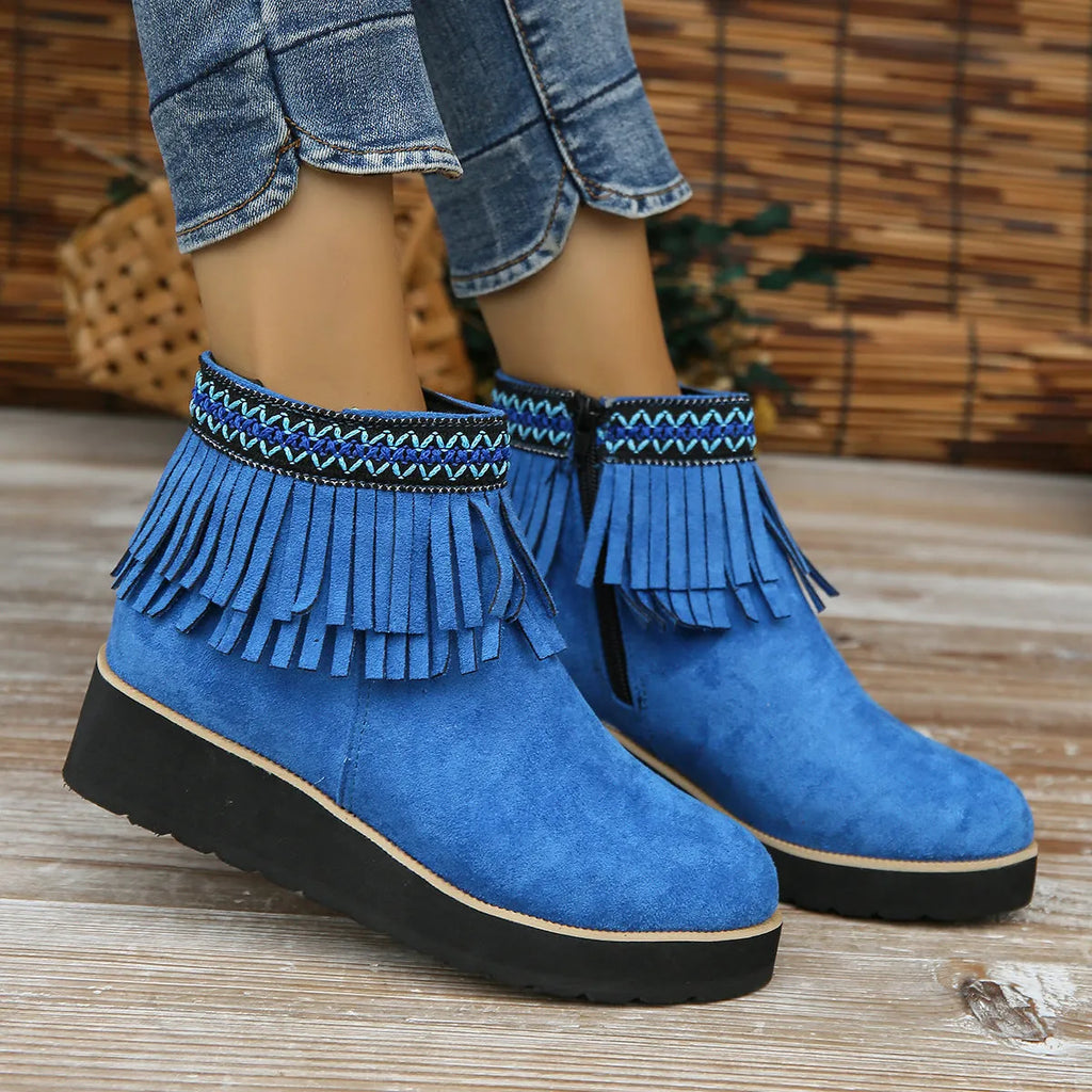 Women's dark brown suede wedge ankle boots with side zipper and tassel detail on a thick rubber sole.